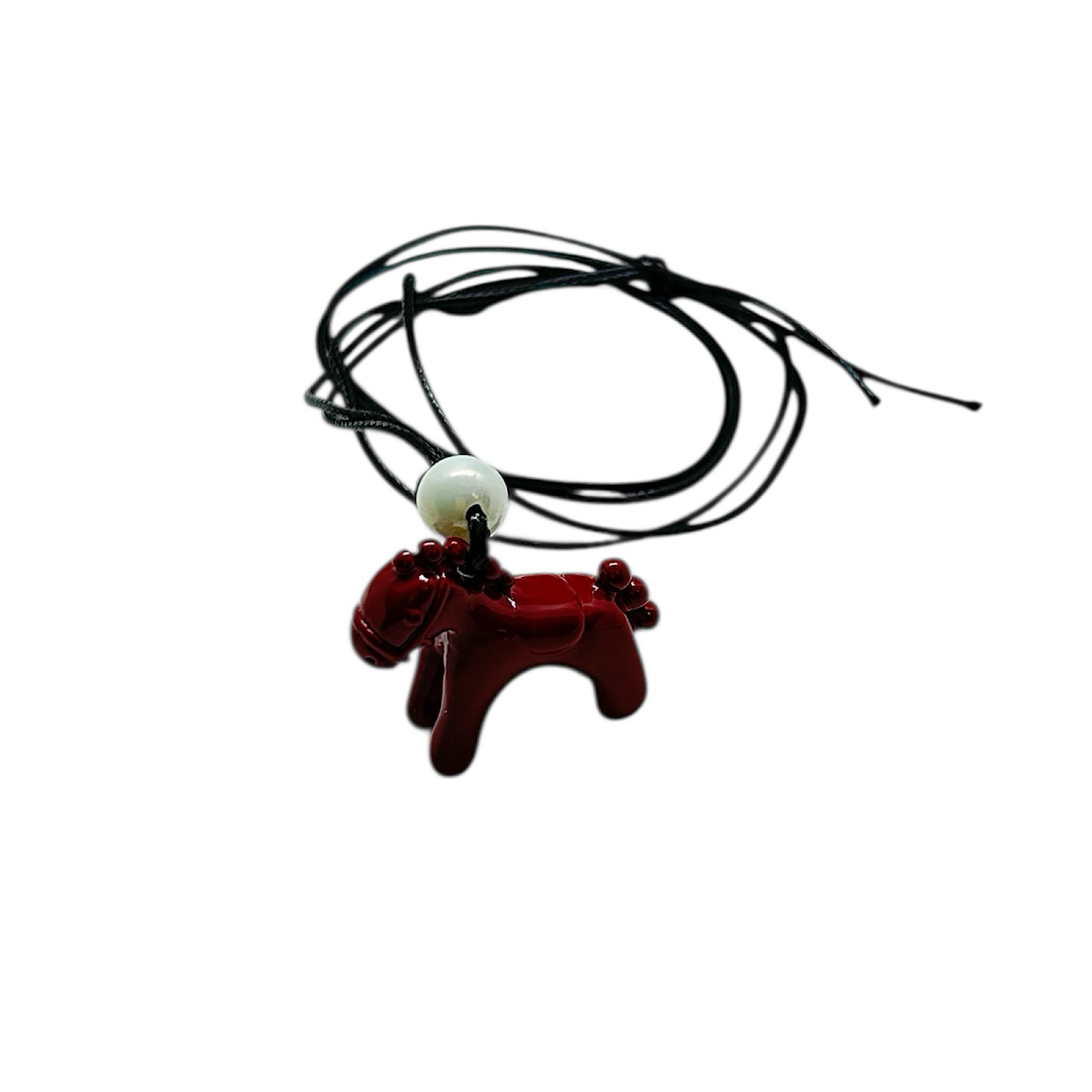 Pendant with black cord and red enamel horse.